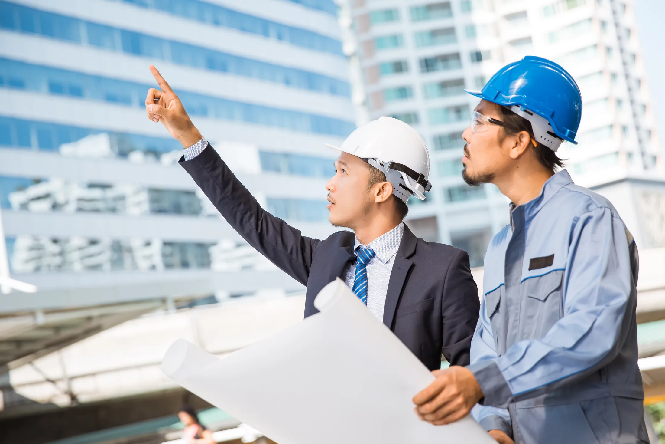 Property development professionals reviewing construction plans in Malaysia